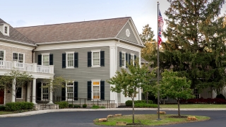 An office on a wooded property designed with an old manor feel.