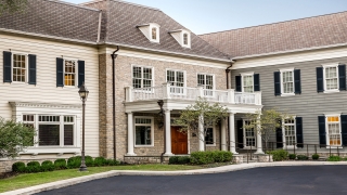 An office on a wooded property designed with an old manor feel.